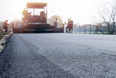 workers-placing-new-coating-asphalt-road